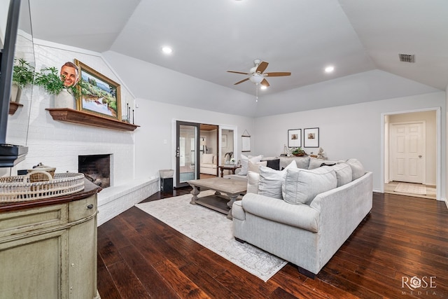 living room with lofted ceiling, wood-type flooring, ceiling fan, a brick fireplace, and recessed lighting