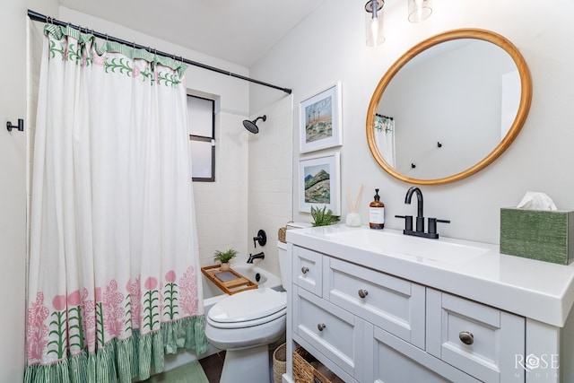 bathroom with toilet, vanity, and shower / bath combo