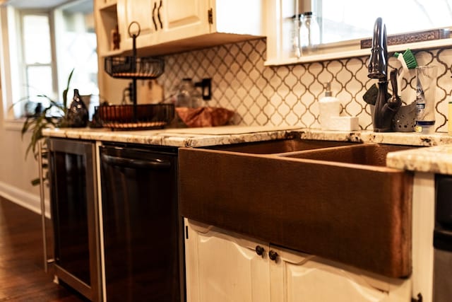 kitchen featuring tasteful backsplash, black dishwasher, white cabinets, and dark hardwood / wood-style flooring