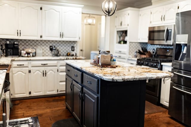 kitchen with white cabinetry, backsplash, a center island, and appliances with stainless steel finishes