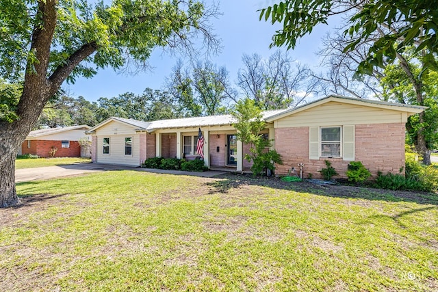 2029 China St, Brady, TX 76825 - ranch-style house featuring brick siding, a front lawn, and driveway