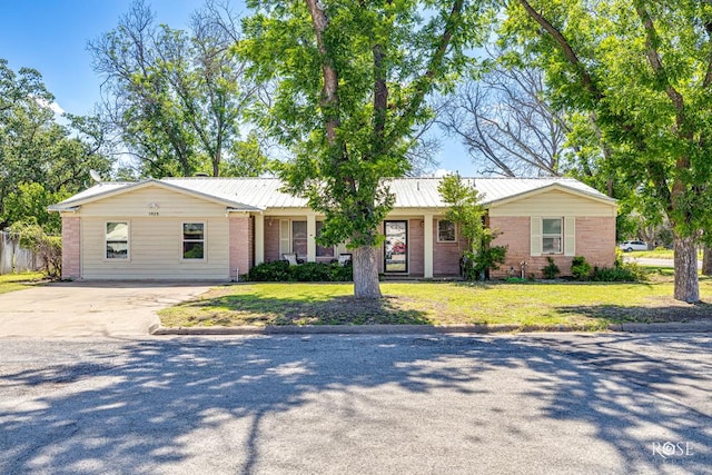 2029 China St, Brady, TX 76825 - ranch-style home with driveway, brick siding, and a metal roof