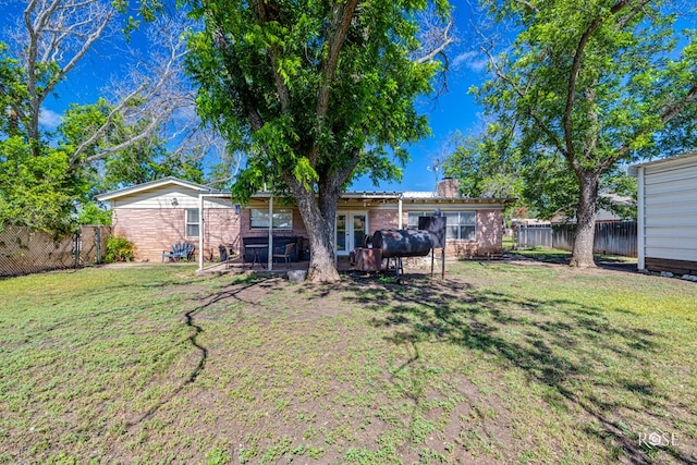 2029 China St, Brady, TX 76825 - fenced backyard featuring french doors
