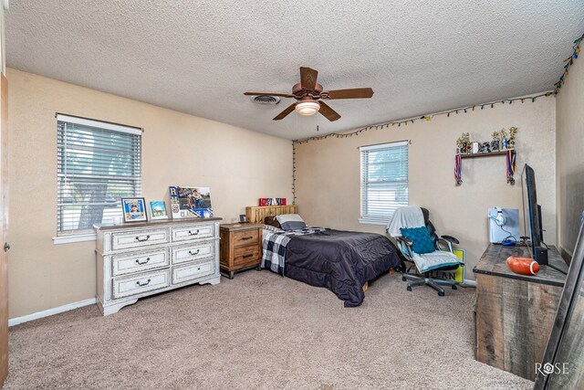 2029 China St, Brady, TX 76825 - bedroom with light colored carpet, a textured ceiling, and a ceiling fan