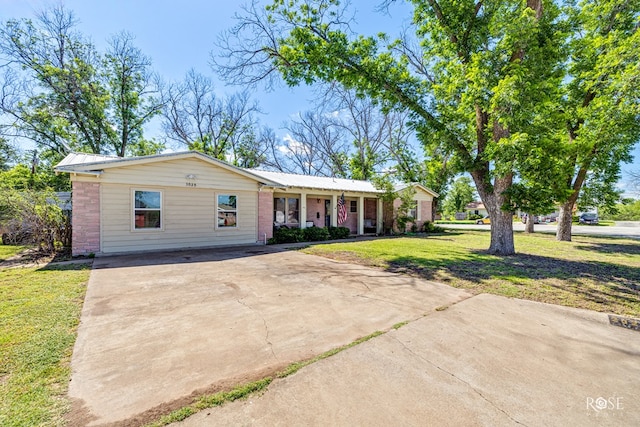 2029 China St, Brady, TX 76825 - ranch-style home featuring driveway, a front lawn, and brick siding