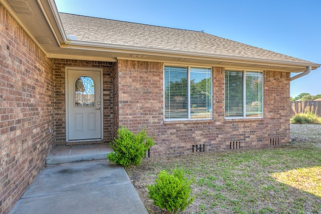 entrance to property with a lawn