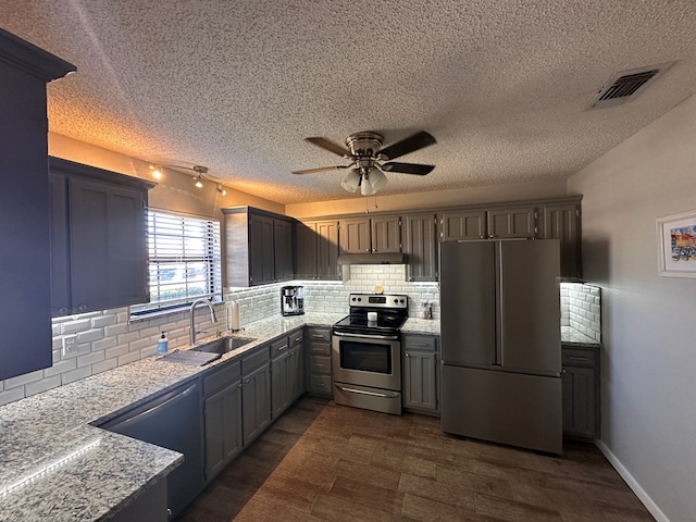 kitchen with dishwashing machine, a sink, visible vents, electric stove, and freestanding refrigerator