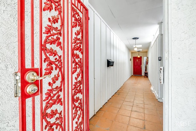 hall featuring light tile patterned flooring