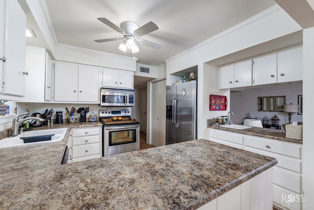 kitchen featuring sink, crown molding, white cabinets, and appliances with stainless steel finishes