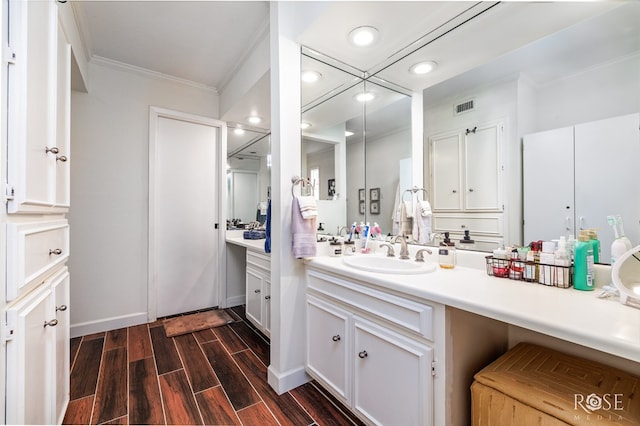 bathroom with ornamental molding and vanity