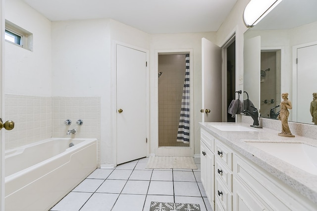 bathroom featuring independent shower and bath, vanity, and tile patterned floors