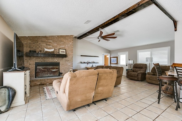 tiled living room with vaulted ceiling with beams, a fireplace, a textured ceiling, and ceiling fan