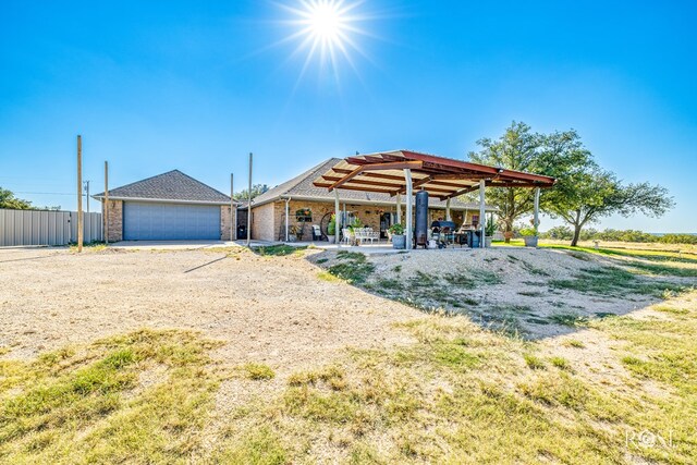 exterior space with brick siding, fence, and a gazebo