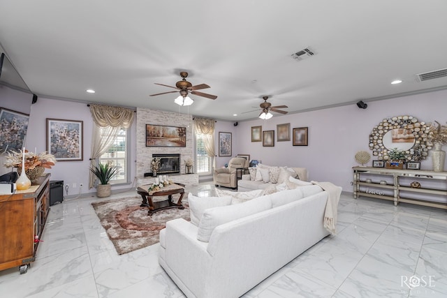 living room featuring ceiling fan, ornamental molding, and a fireplace