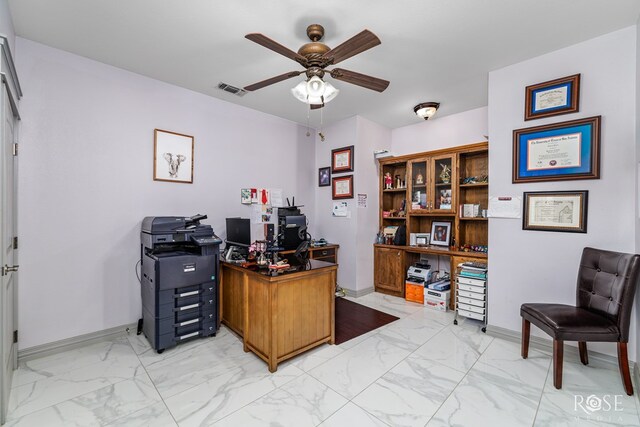 office area with ceiling fan, marble finish floor, visible vents, and baseboards