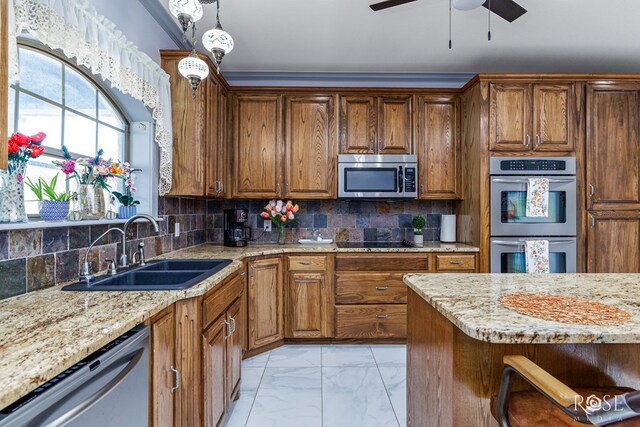 kitchen featuring light stone counters, marble finish floor, stainless steel appliances, backsplash, and a sink