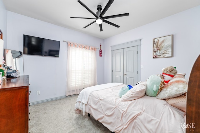 bedroom with light colored carpet, a closet, and ceiling fan