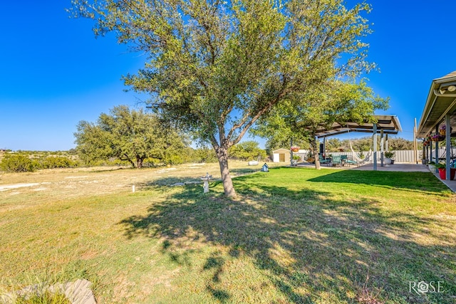 view of yard with a gazebo, a patio, and a storage unit