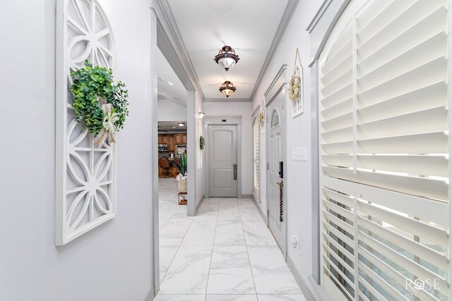 hallway featuring ornamental molding and marble finish floor