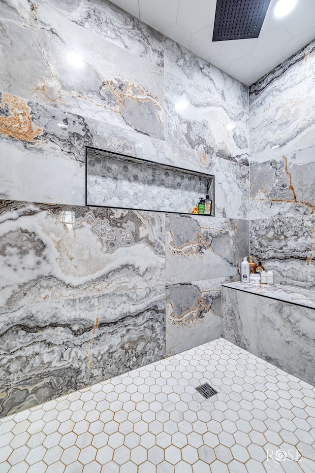 interior details featuring tiled shower