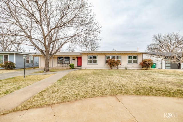 ranch-style house with board and batten siding and a front yard