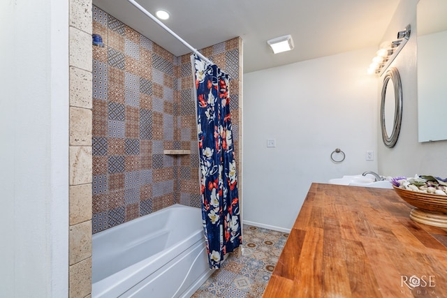 full bathroom with shower / tub combo with curtain, vanity, and baseboards