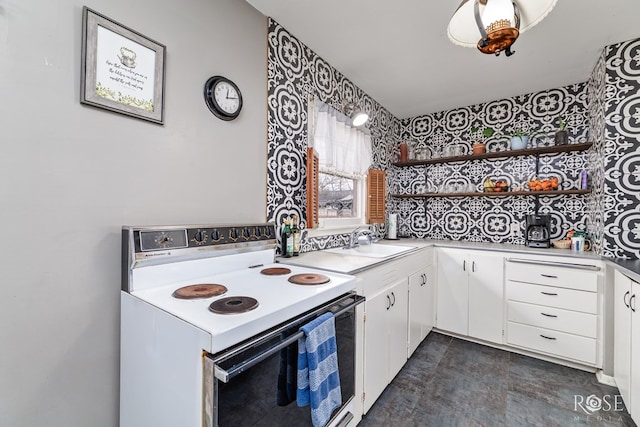 kitchen with open shelves, white cabinets, white range with electric cooktop, and light countertops