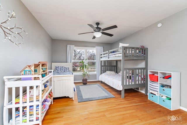 bedroom featuring ceiling fan, wood finished floors, and baseboards