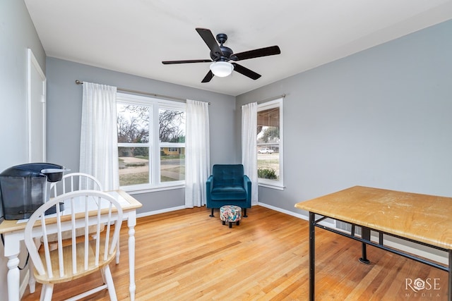 home office with ceiling fan, baseboards, and wood finished floors