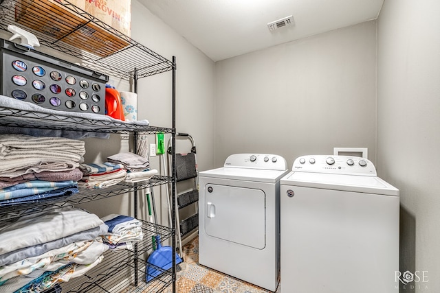 laundry room featuring laundry area, visible vents, and washing machine and clothes dryer