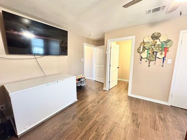 living room with wood-type flooring and ceiling fan