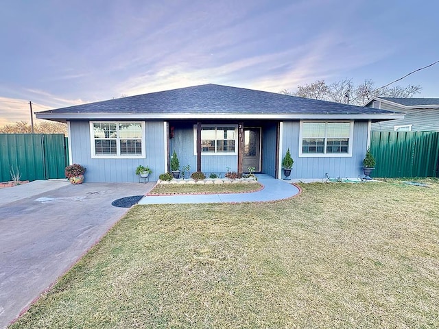 ranch-style home with a front lawn