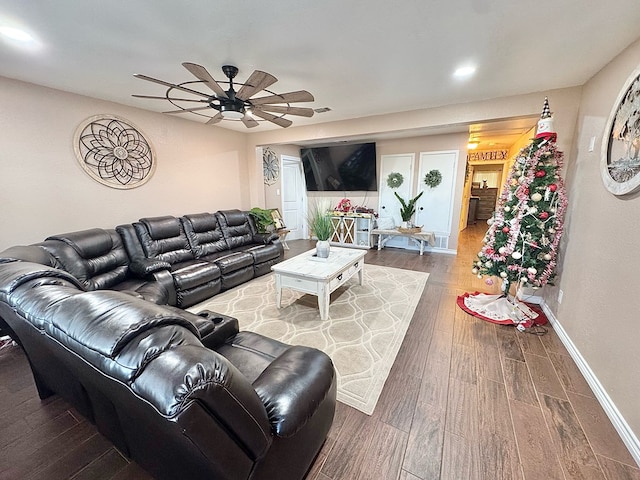 living room featuring wood-type flooring and ceiling fan