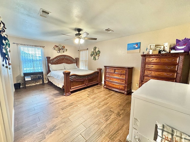 bedroom featuring a textured ceiling and ceiling fan