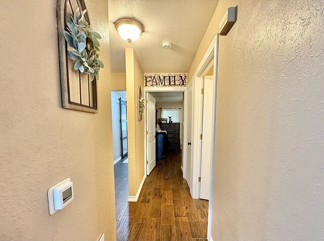 corridor with a textured ceiling