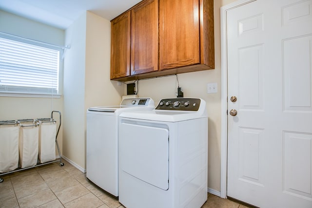 4974 Scarlet Oak Dr, San Angelo, TX 76904 - laundry area featuring washing machine and clothes dryer, cabinet space, and light tile patterned floors