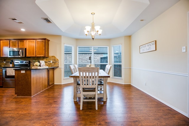 4974 Scarlet Oak Dr, San Angelo, TX 76904 - dining room with a raised ceiling, a chandelier, dark wood-style floors, and recessed lighting