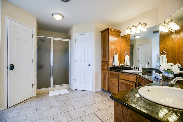 4974 Scarlet Oak Dr, San Angelo, TX 76904 - bathroom featuring double vanity, a stall shower, and tile patterned flooring