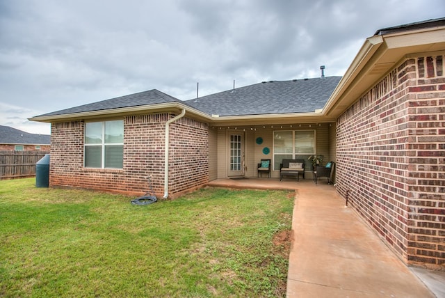 4974 Scarlet Oak Dr, San Angelo, TX 76904 - rear view of house with a shingled roof, brick siding, a patio, and an outdoor hangout area