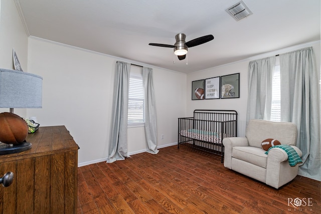 bedroom with visible vents, multiple windows, and wood finished floors