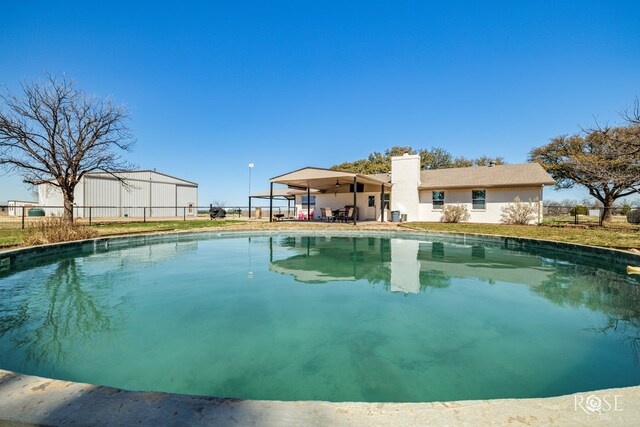 view of pool with a fenced in pool, a patio, a ceiling fan, and fence