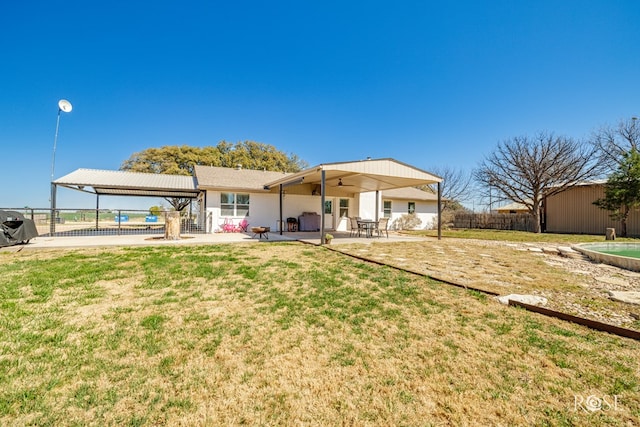 back of property with a gazebo, a patio area, fence, and a lawn