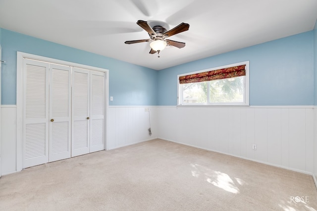 2305 Douglas Dr, San Angelo, TX 76904 - unfurnished bedroom with wainscoting, a closet, carpet floors, and a ceiling fan