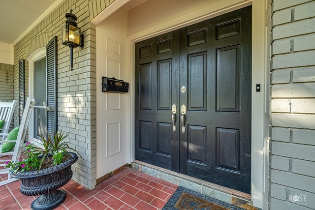 2305 Douglas Dr, San Angelo, TX 76904 - view of exterior entry featuring a porch, french doors, and brick siding