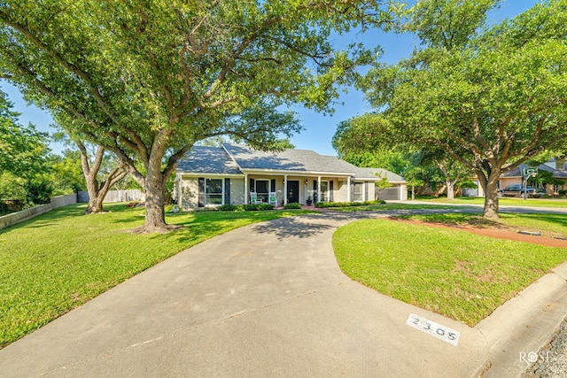 2305 Douglas Dr, San Angelo, TX 76904 - view of front of home featuring concrete driveway, covered porch, and a garage