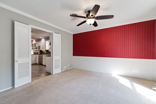 2305 Douglas Dr, San Angelo, TX 76904 - spare room featuring a ceiling fan, dark colored carpet, crown molding, and baseboards