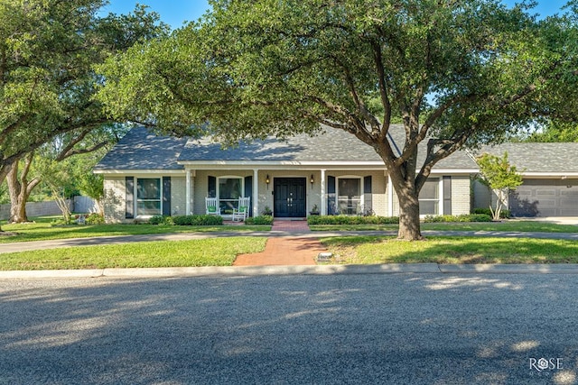 2305 Douglas Dr, San Angelo, TX 76904 - view of front of house featuring covered porch and brick siding