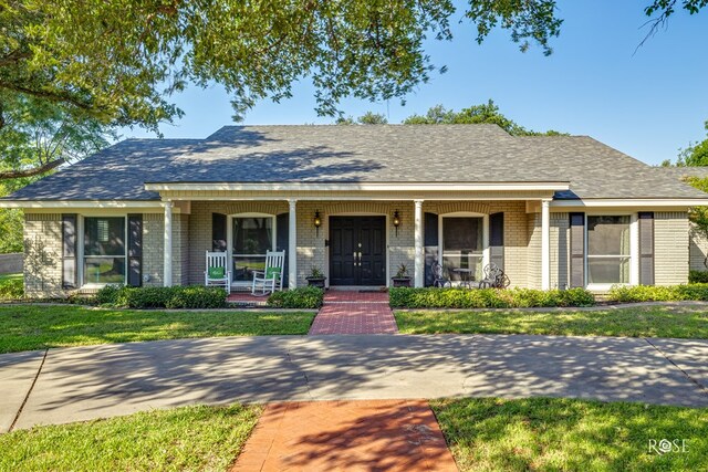 2305 Douglas Dr, San Angelo, TX 76904 - single story home with covered porch, brick siding, and a front lawn