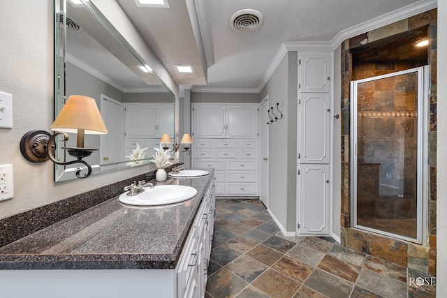 2305 Douglas Dr, San Angelo, TX 76904 - full bathroom with double vanity, stone tile floors, a shower stall, ornamental molding, and baseboards