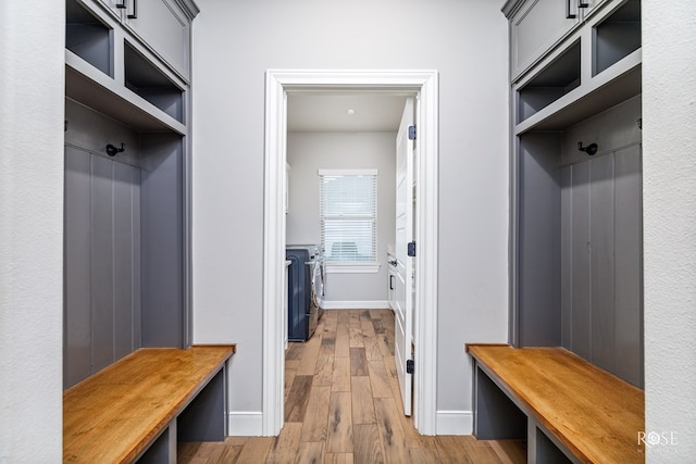 mudroom featuring separate washer and dryer and light wood-type flooring